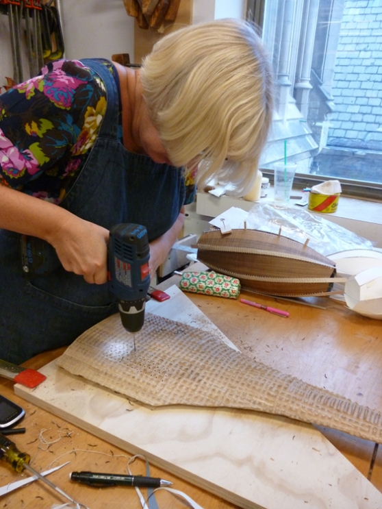 Gaynor drills holes into a carved piece, looks like there's more stitching on the way..